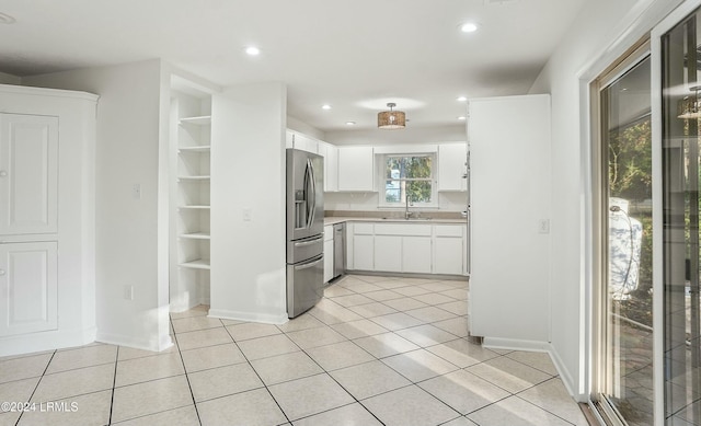 100 Thomas Sumter St, Beaufort, SC 29907 - kitchen with appliances with stainless steel finishes, light countertops, white cabinetry, light tile patterned flooring, and recessed lighting