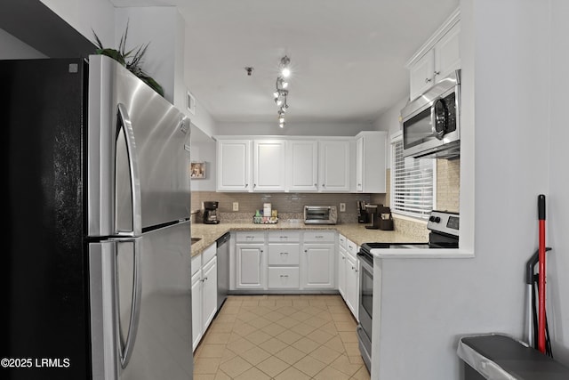 663 William Hilton Pkwy Unit 3321, Hilton Head Island, SC 29928 - kitchen featuring appliances with stainless steel finishes, tasteful backsplash, white cabinetry, and light tile patterned flooring
