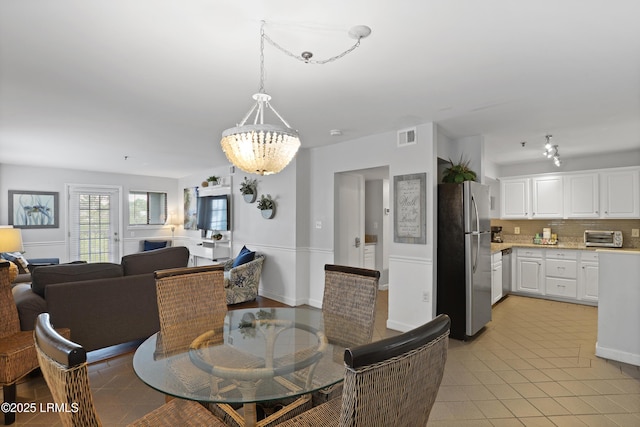 663 William Hilton Pkwy Unit 3321, Hilton Head Island, SC 29928 - dining space with a chandelier and light tile patterned floors