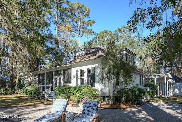 view of home's exterior featuring a sunroom