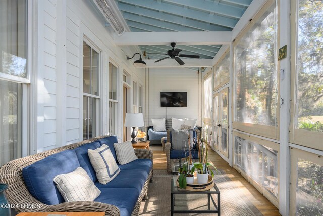 sunroom with vaulted ceiling with beams, plenty of natural light, and ceiling fan