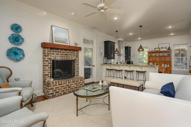 living room with ceiling fan, ornamental molding, and light hardwood / wood-style flooring