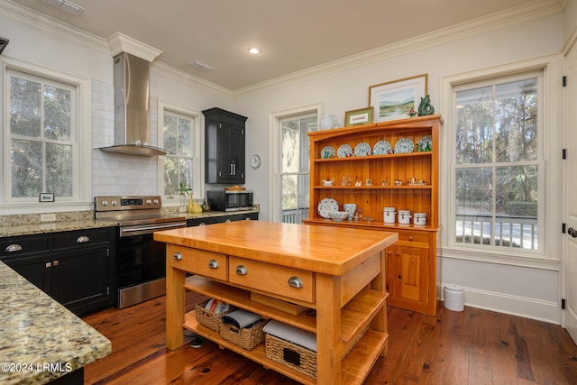 kitchen featuring wall chimney exhaust hood, appliances with stainless steel finishes, light stone countertops, and dark wood-type flooring