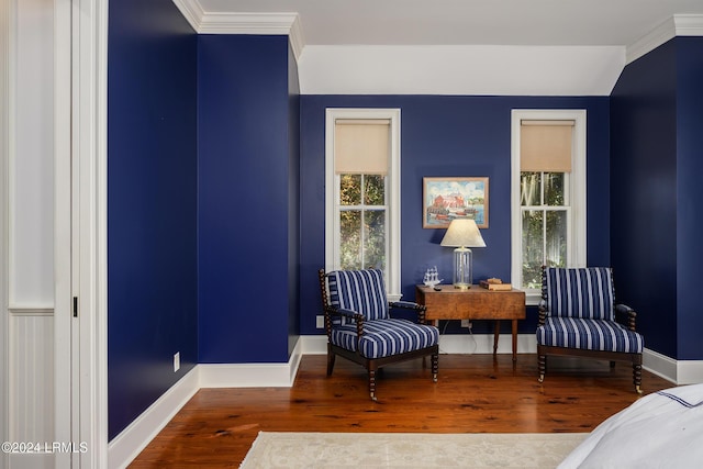 sitting room with hardwood / wood-style floors and ornamental molding