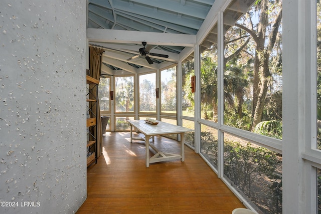 unfurnished sunroom with vaulted ceiling, a healthy amount of sunlight, and ceiling fan