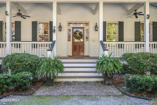 entrance to property with a porch and ceiling fan