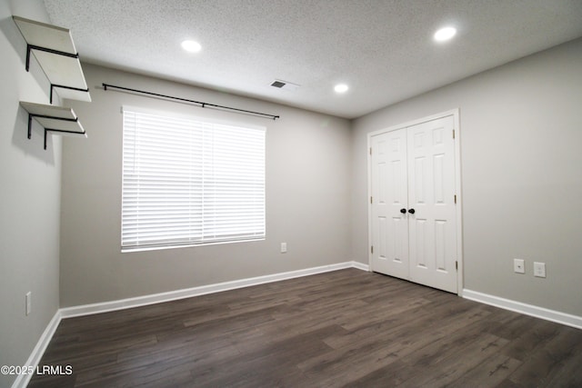 18 Old S Ct Unit 18A, Bluffton, SC 29910 - unfurnished bedroom featuring visible vents, a textured ceiling, dark wood-type flooring, and baseboards