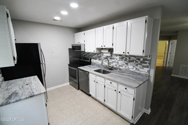 18 Old S Ct Unit 18A, Bluffton, SC 29910 - kitchen featuring a sink, visible vents, white cabinetry, and stainless steel appliances