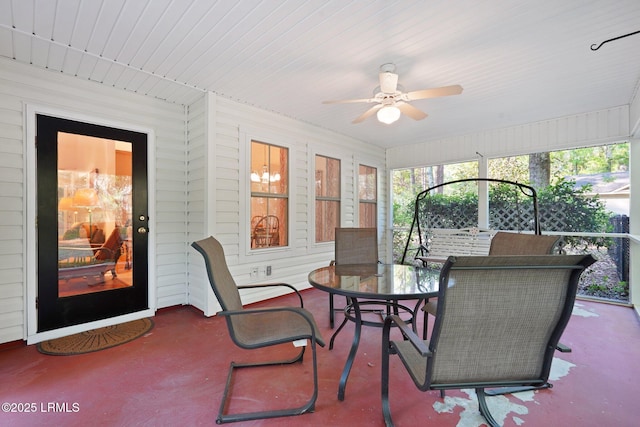 sunroom featuring outdoor dining space and a ceiling fan
