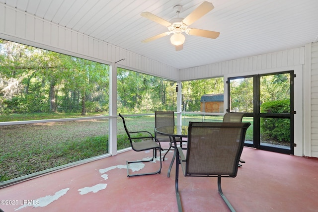 sunroom featuring outdoor dining space and a ceiling fan