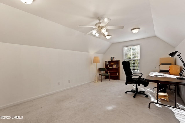 carpeted office space featuring ceiling fan, vaulted ceiling, and baseboards