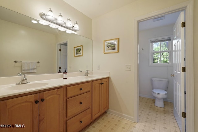 full bathroom featuring tile patterned floors, baseboards, a sink, and toilet