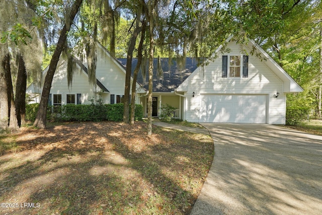 traditional-style home with an attached garage and concrete driveway