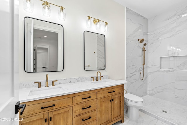 bathroom with marble finish floor, a sink, a marble finish shower, and double vanity