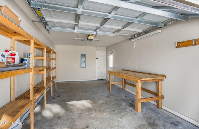 garage with a garage door opener and electric panel