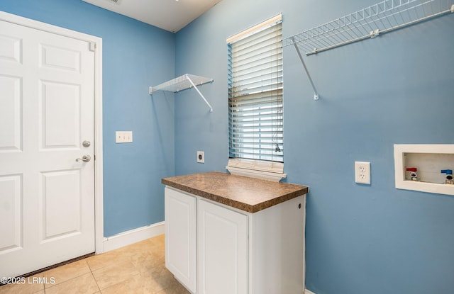 laundry room featuring hookup for a washing machine, hookup for an electric dryer, cabinets, and light tile patterned floors