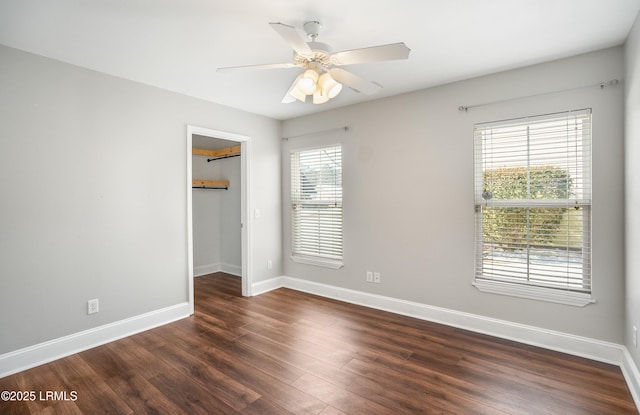 unfurnished room with ceiling fan and dark hardwood / wood-style flooring