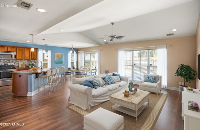 living room featuring lofted ceiling, sink, dark wood-type flooring, and ceiling fan