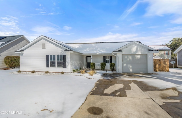 single story home featuring a garage and covered porch