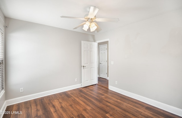 empty room with dark wood-type flooring and ceiling fan