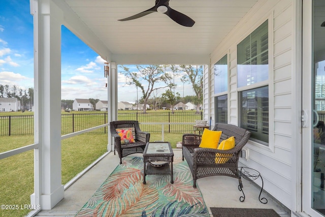 sunroom / solarium with a ceiling fan