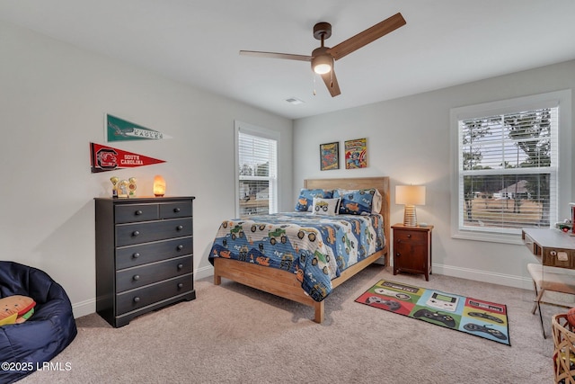 carpeted bedroom featuring ceiling fan and baseboards