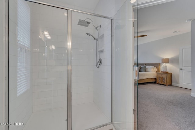 ensuite bathroom featuring a stall shower and connected bathroom