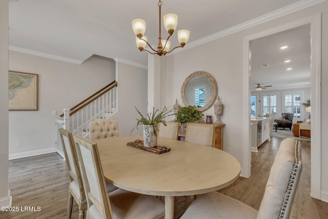 dining area featuring ornamental molding, stairway, baseboards, and wood finished floors