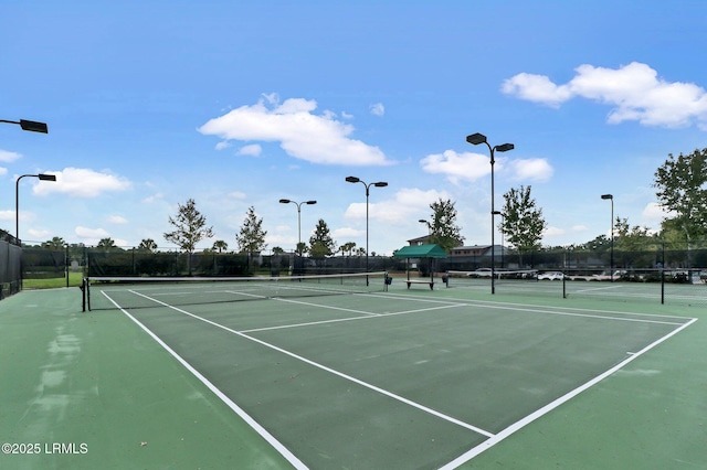 view of tennis court featuring fence