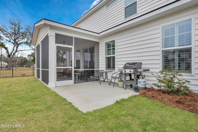 view of patio featuring a sunroom, a grill, and fence