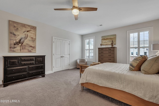 carpeted bedroom featuring visible vents, ceiling fan, and baseboards