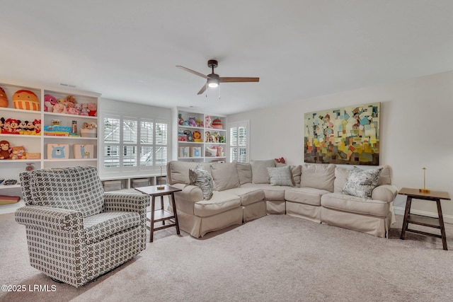 living room featuring carpet floors and a ceiling fan