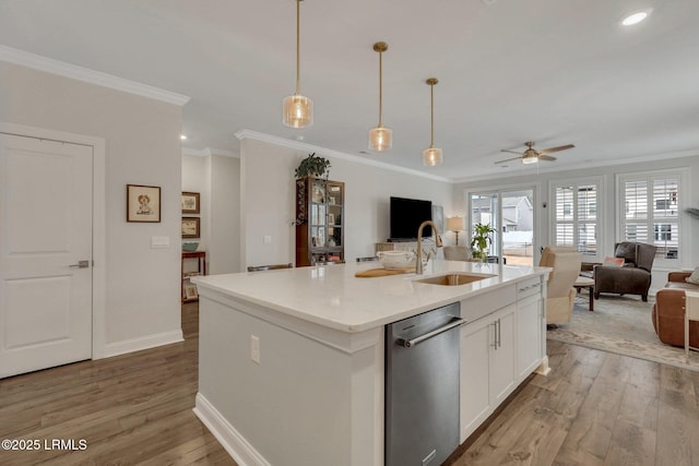 kitchen with open floor plan, light wood-style floors, a sink, and dishwasher