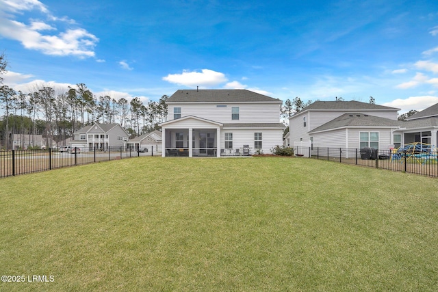 back of property with a sunroom, a fenced backyard, and a lawn