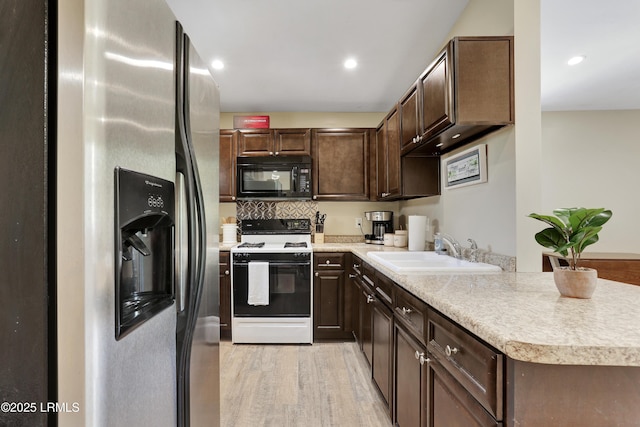 2503 Twin Oaks Ln, Port Royal, SC 29935 - kitchen featuring black microwave, range with gas stovetop, stainless steel fridge with ice dispenser, a sink, and dark brown cabinets