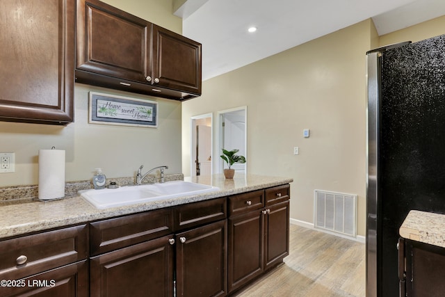 2503 Twin Oaks Ln, Port Royal, SC 29935 - kitchen with a sink, light countertops, light wood finished floors, dark brown cabinetry, and recessed lighting