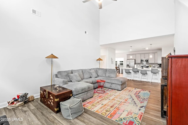 400 Ramport St, Ridgeland, SC 29936 - living room featuring visible vents, light wood-style flooring, ceiling fan, and a high ceiling
