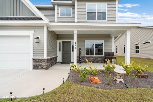 400 Ramport St, Ridgeland, SC 29936 - entrance to property featuring a garage, board and batten siding, a porch, and stone siding