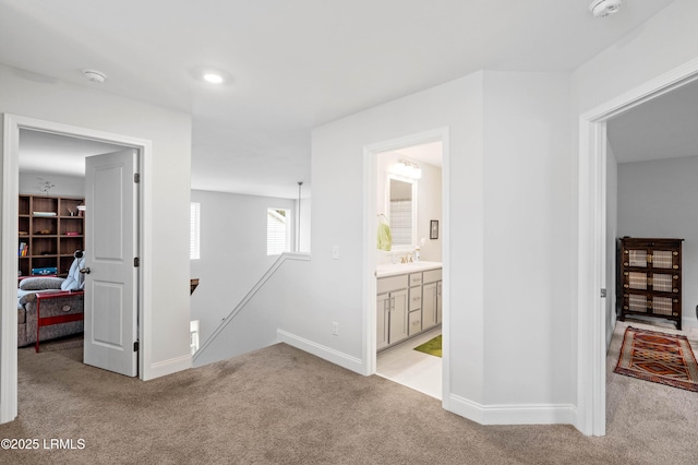 400 Ramport St, Ridgeland, SC 29936 - corridor with light colored carpet, a sink, baseboards, and an upstairs landing