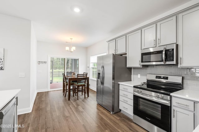 400 Ramport St, Ridgeland, SC 29936 - kitchen featuring an inviting chandelier, decorative backsplash, dark wood-type flooring, light countertops, and stainless steel appliances