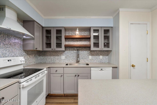 kitchen with sink, backsplash, white appliances, and wall chimney exhaust hood