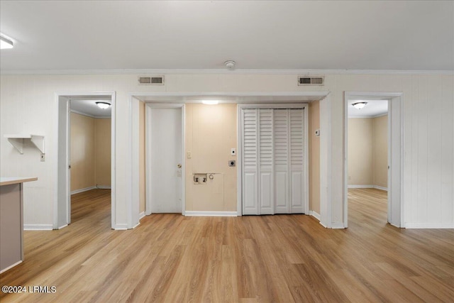 interior space featuring crown molding and light wood-type flooring