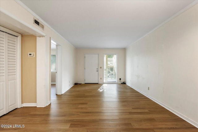 foyer featuring crown molding and hardwood / wood-style floors