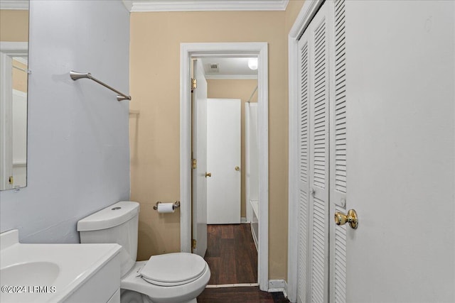 bathroom with ornamental molding, hardwood / wood-style floors, vanity, and toilet