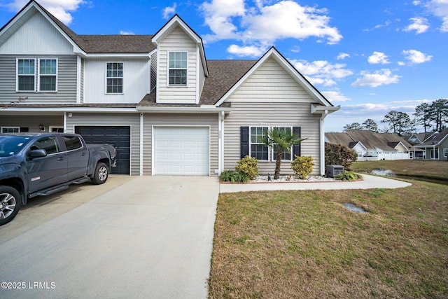 view of front of property featuring central AC unit, an attached garage, driveway, roof with shingles, and a front yard