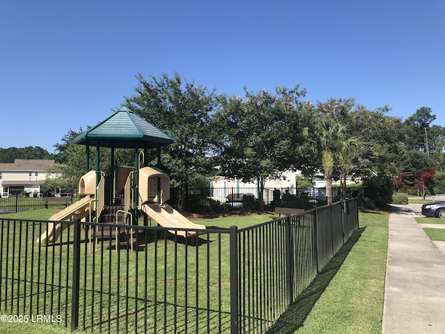 communal playground with a yard and fence