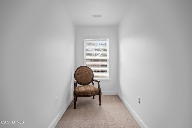 sitting room with visible vents, light carpet, and baseboards