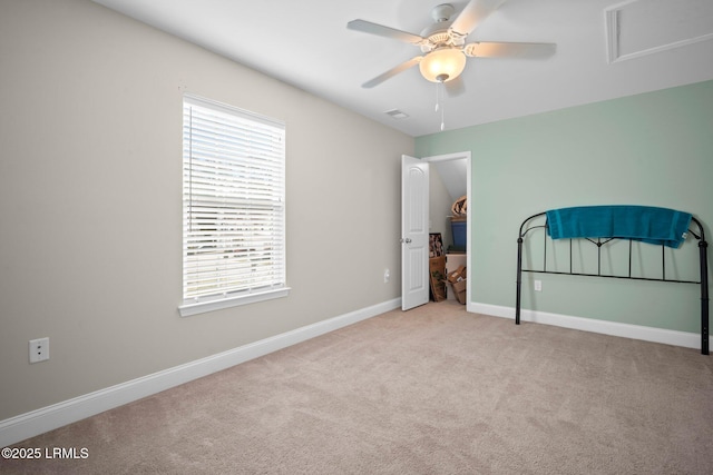 unfurnished bedroom featuring a ceiling fan, light carpet, and baseboards