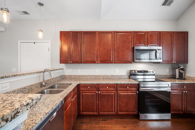360 Dante Cir, Beaufort, SC 29906 - kitchen featuring stainless steel appliances, a sink, dark brown cabinets, dark wood-style flooring, and light stone counters