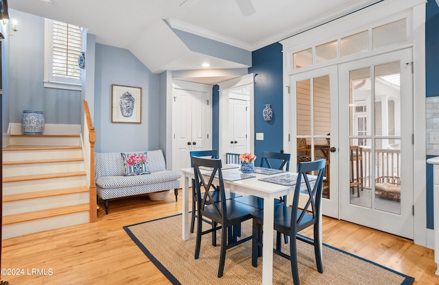 dining space with light hardwood / wood-style flooring, ornamental molding, french doors, and ceiling fan